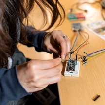 Team Member at desk working on small circuit board