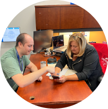 Two college interns at Universal Creative examining a wheel from a ride.