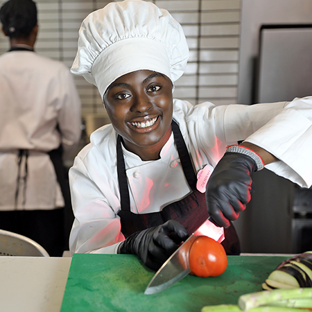 Culinary Team Member prepping vegetables