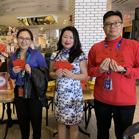 3 Asian Team Members holding red envelopes