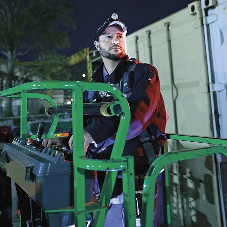 Technical Services Team Member operating electrical high reach equipment.