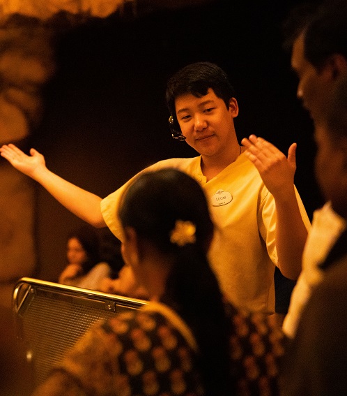 Team member directing guests through a tour.