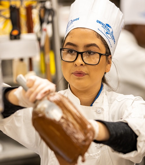 Chef at Universal Studios Hollywood restaurant prepares a decadent treat