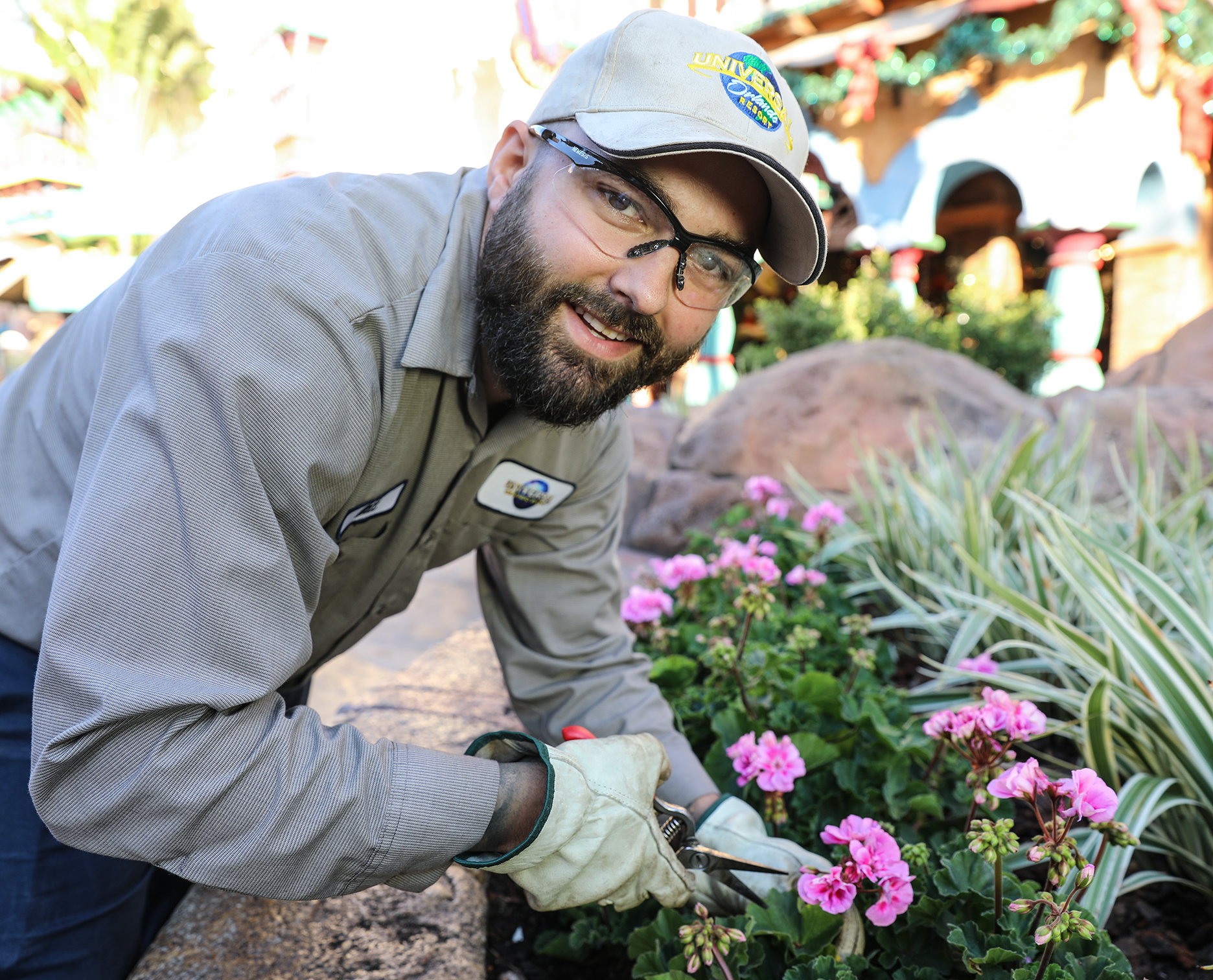 man trimming plants and flowers