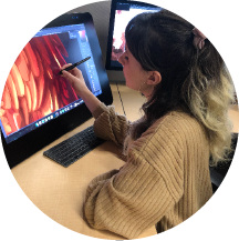 Close up of a woman holding stylus pen editing creative photo using a computer.