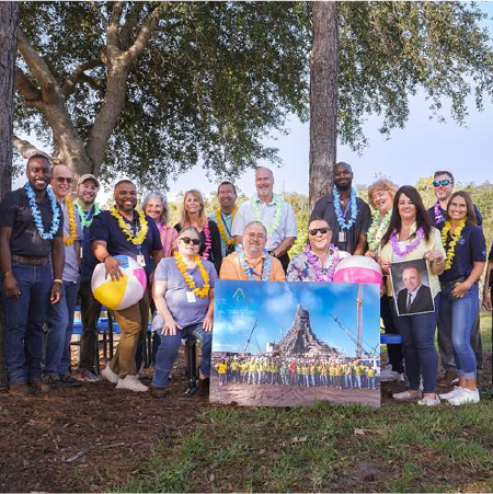 Group of Universal Creative Team Members with a photo of Volcano Bay