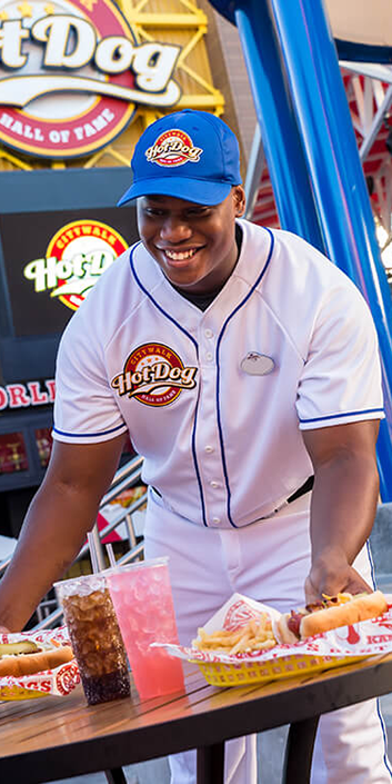 A Team Member placing two baskets of food on a table.
