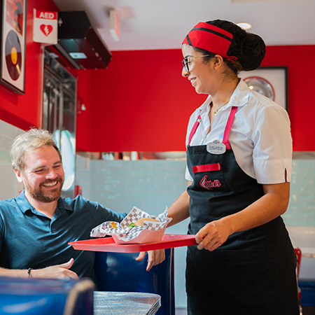 Woman giving a man a tray of food