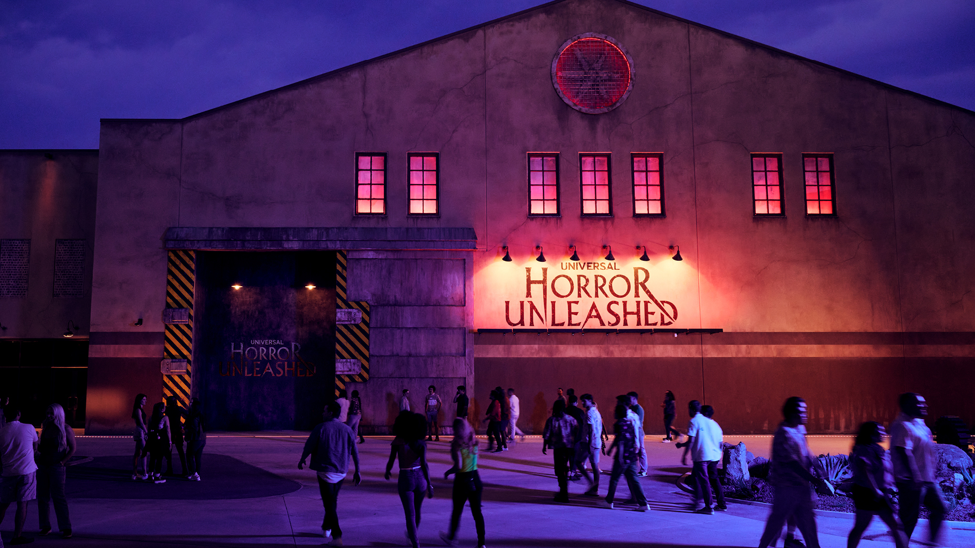 B004_KPH8672_072425_R2-16x9-1920x1080_000 people walking around the entrance of Universal Horror Unleashed
