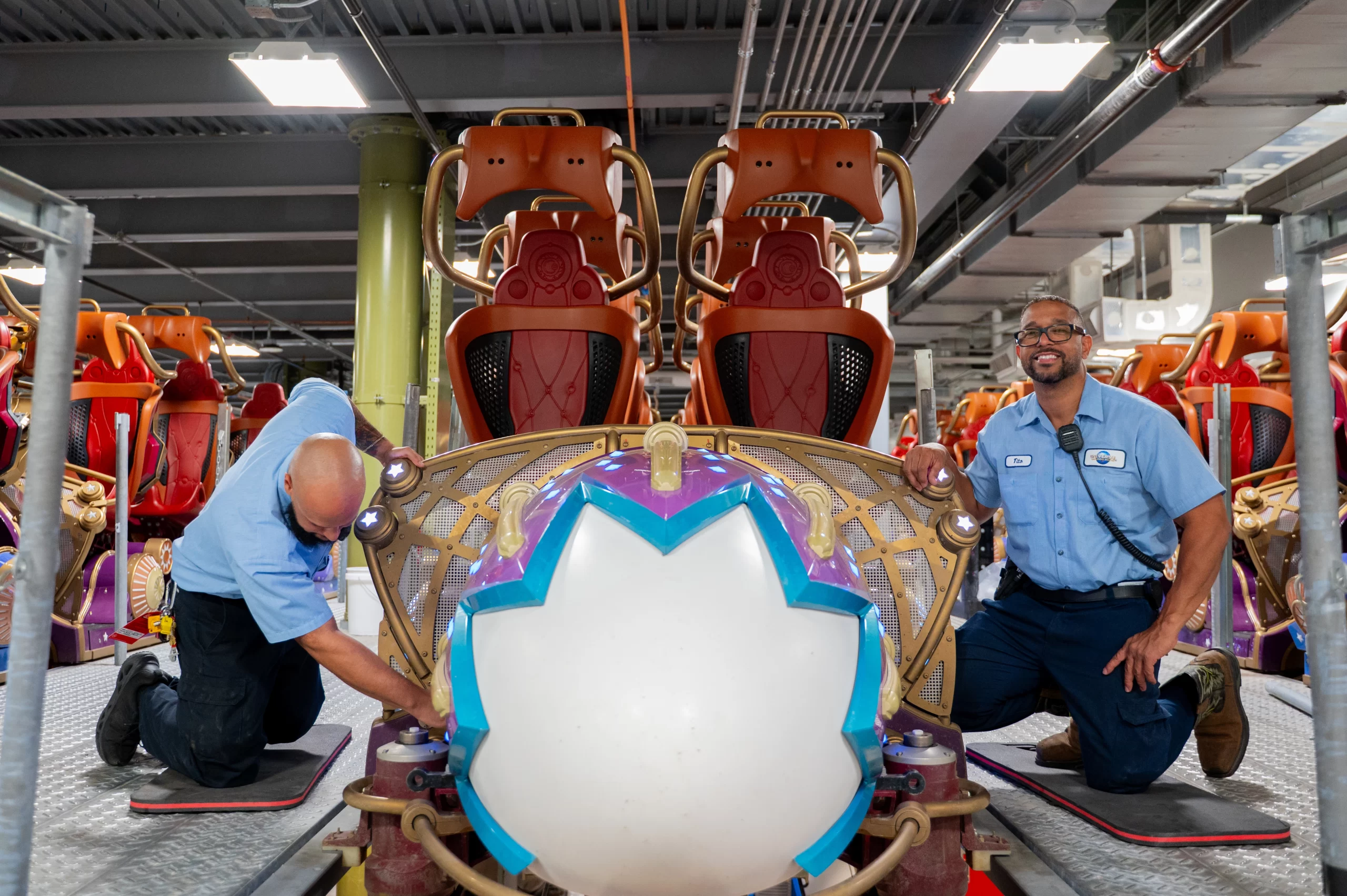 Two techs working on a train for Stardust Racers