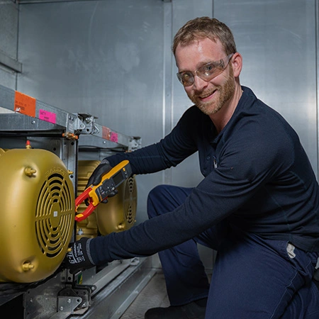 a Team Member working on an HVAC unit