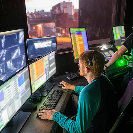 Technical Entertainment Team Member overseeing a show's controls